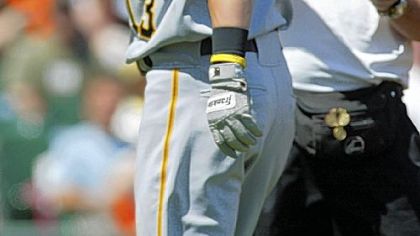 Pirates' Nate McLouth, left, has his right hand checked by trainer Brad Henderson after being hit by a pitch yesterday.