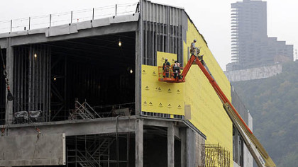 Construction crews work on the exterior of the North Shore casino yesterday.