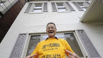 Joseph Bruni shows off his T-shirt outside his office on Greentree Road in the West End yesterday.