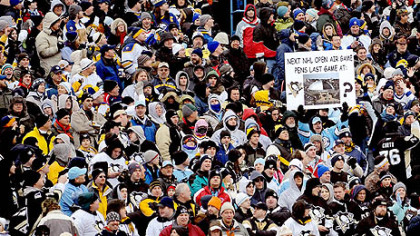 A Pittsburgh fan holds a sign suggesting the Penguins play an open-air game at Mellon Arena before they move into their new building.