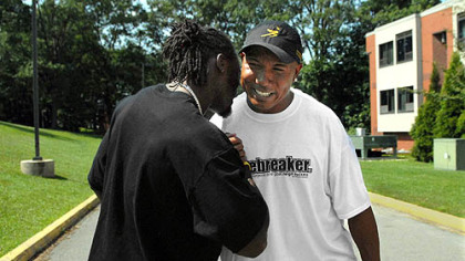Hines Ward greets Santonio Holmes as they arrive  at St. Vincent College for the start of training camp.