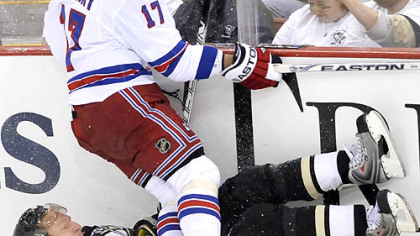 Rangers Brandon Dubinsky topples Penguins Marian Hossa against the boards.