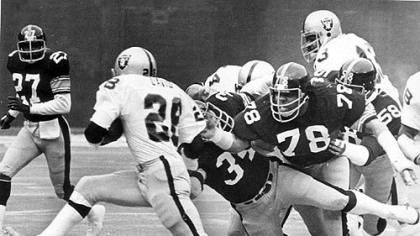 Andy Russell (34), Dwight White (78) and Jack Lambert (58) collar Clarence Davis after a 7 yard gain in this 1976 photo.