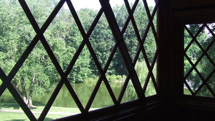 A large window on the second-floor of the Canopy Cathedral treehouse offers visitors a view of the Italian water garden.