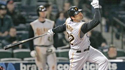 The Pirates' Xavier Nady follows through on a three-run home run in the 12th inning.