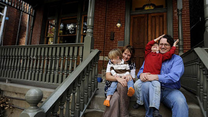 Pittsburgh's new URA director Rob Stephany and his wife, Molly, holding Eliott, 2 (left), and Oliver, 4, on the porch of their Lawrenceville home.