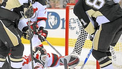 Miroslav Satan muscles the Penguins' only goal of the game past New Jersey goaltender Martin Brodeur.