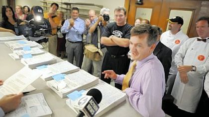 Sean Casey, owner of the Church Brew Works, presents drink tax petitions yesterday.