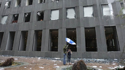 HOUSTON -- Matt Schlabach and Meredith Borders look at the damage casused by Hurricane Ike to the JPMorgan Chase Tower Saturday.