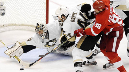 Marc-Andre Fleury makes a save in front of the Red Wings' Tomas Holmstrom.