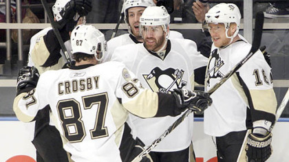 Sidney Crosby celebrates with teammates after Marian Hossa, right, scored the first goal of the game. For more photos, please click on the image links to the left.