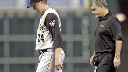 Tom Gorzelanny leaves last night's game in the third inning with the Pirates' trainer in tow.