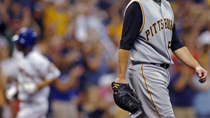 Zach Duke, right, reacts after giving up a home run to Milwaukee Brewers' J.J. Hardy, left, in the fifth inning.