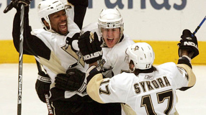 Evgeni Malkin, middle, celebrates with Georges Laraque, left, and Petr Sykora after Laraque's goal in the first period last night at Madison Square Garden. Malkin had an assist on the goal and also scored twice to help the Penguins take a 3-0 lead in the series.