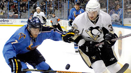 Atlanta's Mark Popovic, left, and the Penguins' Jeff Taffe vie for the puck.