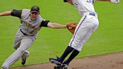 Pirates shortstop Jack Wilson tags out the Brewers' Gabe Kapler, who was caught in a run down in the sixth inning.