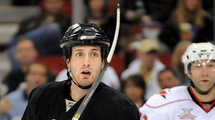 Brooks Orpik takes New Jersey's Sergei Brylin into the boards Monday.