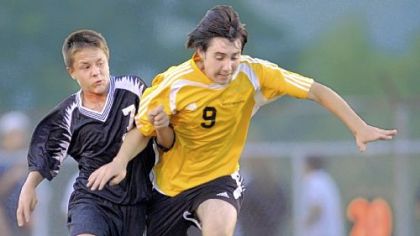Monessen's Coby Matush, left, and Bentworth's Shawn Ross fight for the ball last night.