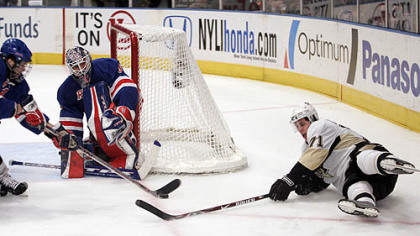 New York Rangers goalie Henrik Lundqvist and Paul Mara, left, defend the net as the Penguins'' Evgeni Malkin (71) reaches out for the puck during the first period of their NHL hockey game at Madison Square Garden in New York last night.