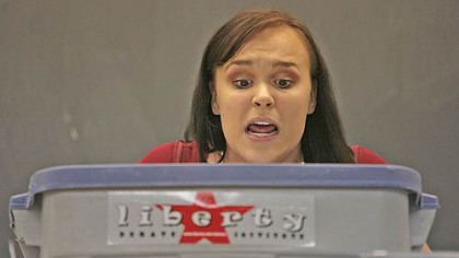 Jackie Poapst, 19, a history major at Liberty University of Virginia, reads several cards of information as quickly as possible breaking only for a quick breath of air as she delivers her team's rebuttal remarks.