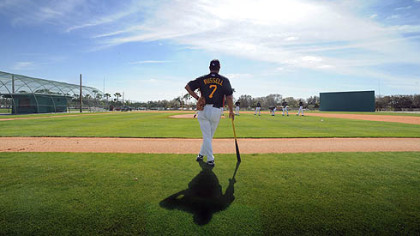 Pirates manager John Russell watches pitchers during workouts at Pirate City.