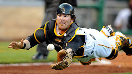 The Pirates' catcher Ryan Doumit makes a diving attempt on bunted ball by the Diamondbacks' pitcher Brandon Webb in the second inning tonight.