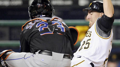 Adam LaRoche is tagged out at home plate by Mets Brian Schneider in the seventh inning last night.