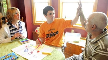 Post-Gazette
Mark and Barbara Wallace work with their autistic son, Matty, 15, at one of his favorite activities, drawing with markers. Matty is the subject of an award-winning documentary by his former baby sitter, Jaclyn Spirer.