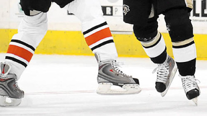 Penguins Tyler Kennedy takes a right from Flyers Scottie Upshaw in the first period.