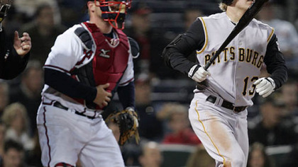 The Pirates' Nate McLouth (13) and Atlanta Braves catcher Brian McCann watch McLouth's three-run home run in the eighth inning of their MLB baseball game last night in Atlanta.
