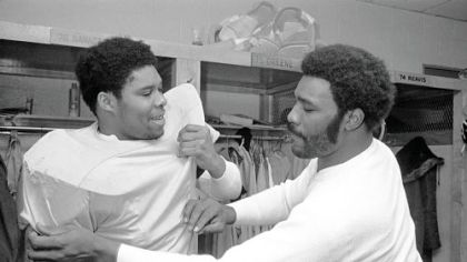 In this Jan 12. 1976 file photo, Steelers defensive lineman Dwight White, left, and Joe Greene prepare for a practice session.