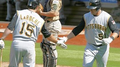 Padres catcher Nick Hundley looks down as Pirates' Andy LaRoche, left, congratulates teammate Steve Pearce after Pearce hit a home run yesterday in the fourth inning.