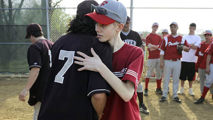 John Challis gets a hug from Beaver's Al Torrence after the two teams played on April 24.