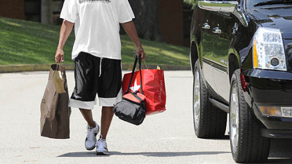 Hines Ward carries his stuff into the dorm at St. Vincent College at the start of training camp.