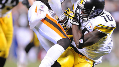 Steelers receiver Santonio Holmes picks up a first down against the Browns' Eric Wright.