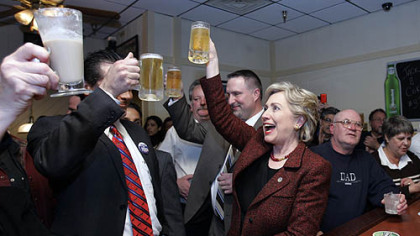 Democratic presidential hopeful, Sen. Hillary Rodham Clinton, D-N.Y., raises her mug of beer in a toast with Hammond, Ind., Mayor Tom McDermott, left,  as she stops at the bar during a campaign stop at Bronko's restaurant in Crown Point, Ind., yesterday.