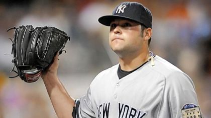 Yankees starter Joba Chamberlain waves to the fans after leaving the game in the seventh inning. Chamberlain picked up his second win by allowing just six hits and no runs. He also struck out seven.