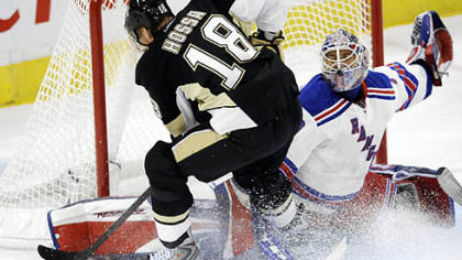 The Rangers' Henrik Lundqvist stops a shot by the Penguins' Marian Hossa in the first period.