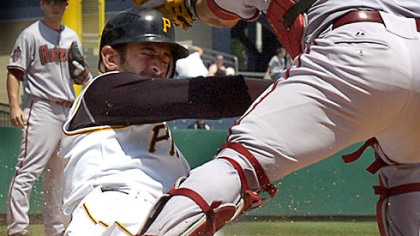 Pirates corner infielder Jose Bautista, left, is tagged out by Diamondbacks catcher Miquel Montero in the sixth inning.