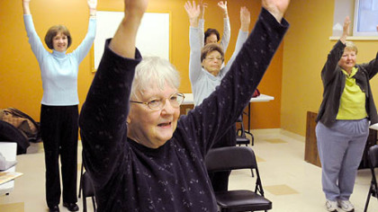 Sue Beard of McCandless holds her arms up with her classmates during the exercise session held at the Ingomar United Methodist Church. She has been with the class for four years and is certified as an instructor.