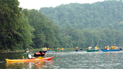 Judy Tubbs of Greensburg enjoys a day on the Youghiogheny River with her dogs, Benny and Sissy. Participants will paddle, bike, camp and fish on or near the river during the Youghiogheny River Sojourn, July 17-20.