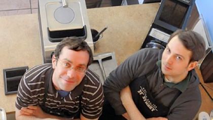 21st Street Coffee and Tea co-owners Luke Shaffer, left, and Dominic Demangone stand behind the counter of their Strip District store. Alexis Shaffer, not pictured, is also a co-owner. A second store is in the Frick Building, Downtown.