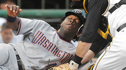 A bigger night: Ryan Doumit tags out Lastings Milledge.