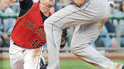 The Blue Jays' Alex Rios ducks under the throw of Pirates third baseman Doug Mientkiewicz last night at PNC Park.