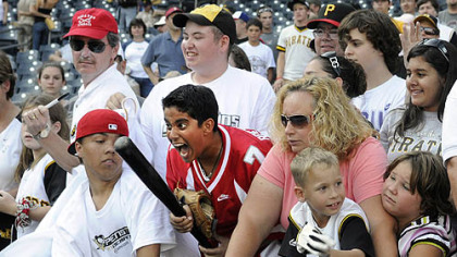 Amal Chabra, 12, of Sewickley, reacts after getting a bat from Pirates player Jack Wilson after the Pirates' last home game.
