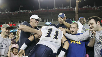 Fans celebrate with Pitt quarterback Bill Stull, who jumped into the stands following the Panthers' upset over No. 10 South Florida.