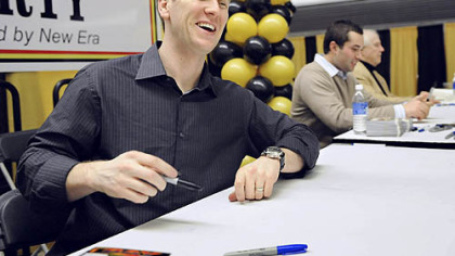 Jason Bay happily signs autographs along with Neil Walker and Bob Friend at PirateFest at the David L. Lawrence Convention Center last night. But he wasn't happy that Pirates management didn't make any big moves in the offseason.