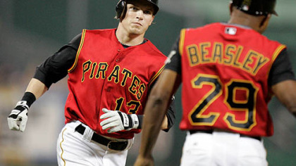 Nate McLouth, left, rounds third to greetings from coach Tony Beasley (29) after hitting a fifth-inning solo homer off Milwaukee Brewers    pitcher Dave Bush in a baseball game at PNC Park last night.