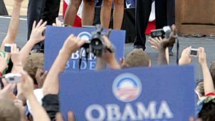 Barack Obama, left, his wife, Michelle, Joe Biden, Democratic senator from Delaware, right, and his wife Jill, wave to supporters during a rally yesterday.