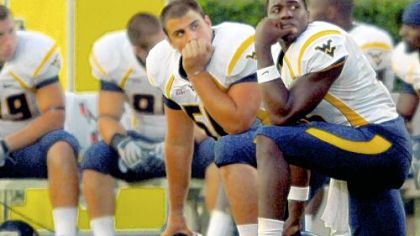 West Virginia's Gino Gradkowski, left, and P.J. Shirdan watch the clock wind down yesterday at East Carolina, where the No. 8 Mountaineers were upset.